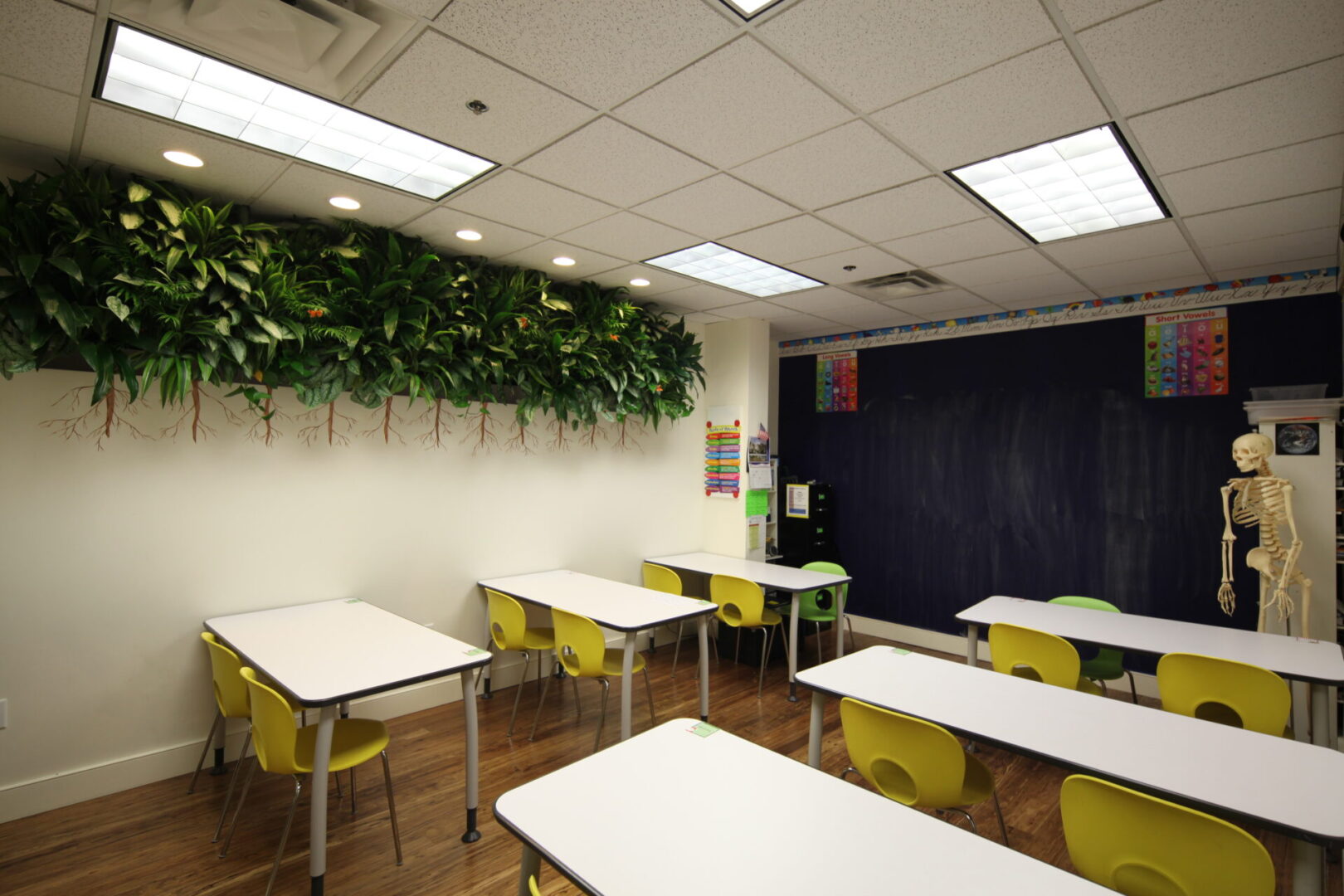 A classroom with tables and chairs in it