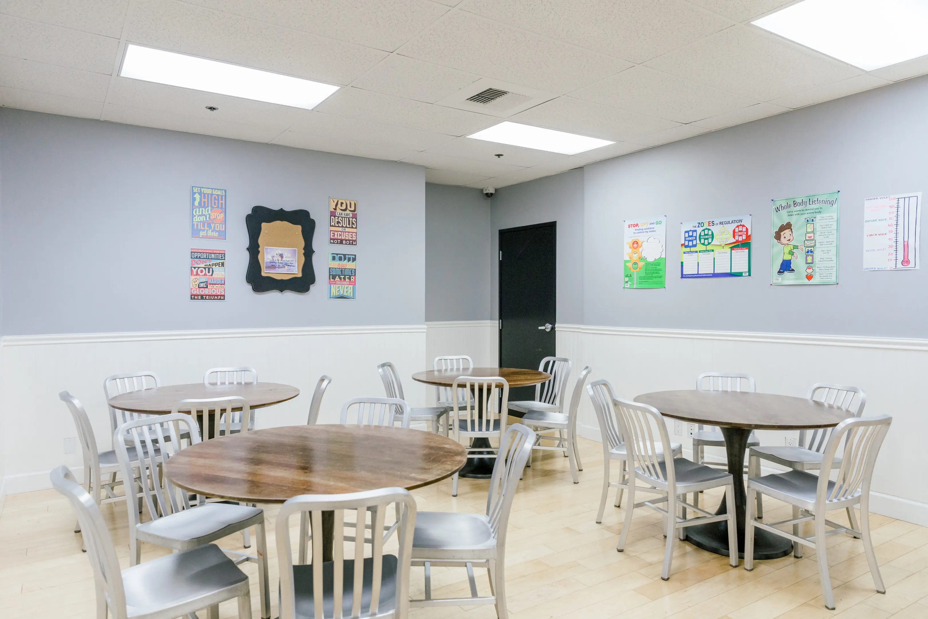 A room with many tables and chairs in it