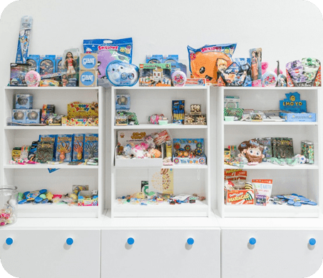 A white shelf with many toys on it